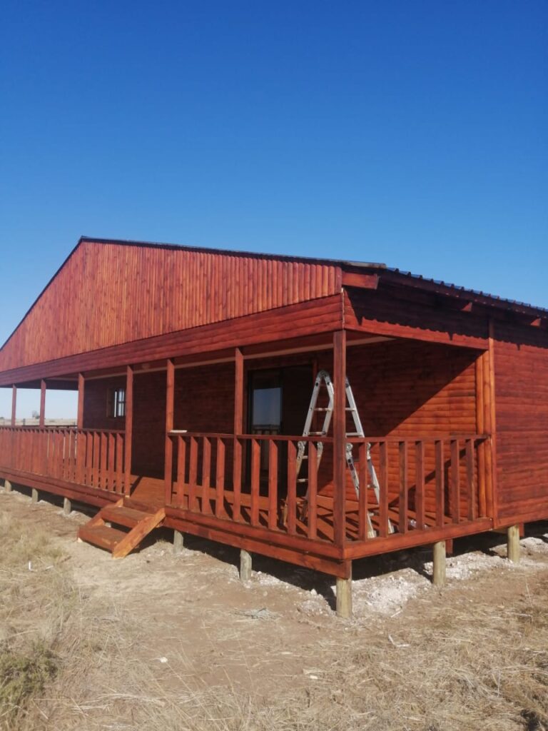With toungue and groove flooring on CCA treated stilts 300mm to 500mm above ground and aluminum sliding door and windows and ibr roof sheets on trusses, and knottypine drywalling and ceilings